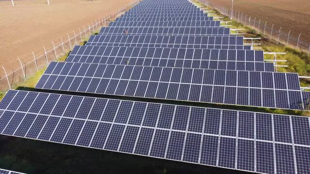 Solar panels farm in the middle of a plowed field