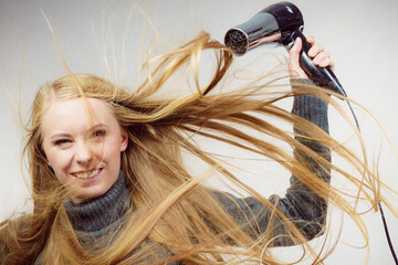 Woman styling her long hair
