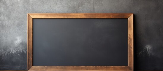 A brown rectangular blackboard with a wooden frame is placed in front of a flat panel display. The wood stain gives it a hardwood look, making it a multimedia display device