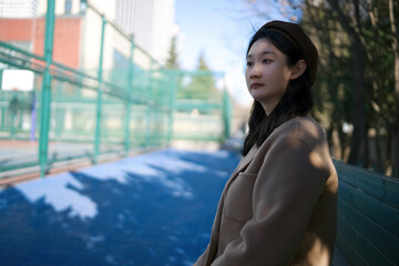 Serene Winter Day - Young Woman Contemplating in Park