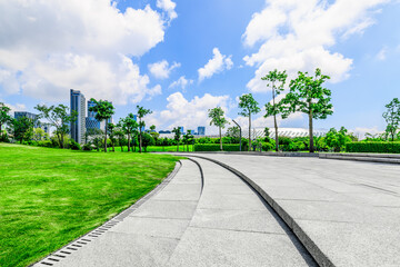 Empty square floor and trees with buildings in park