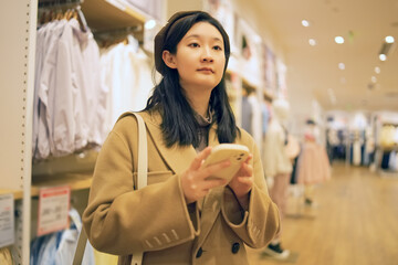 Young Woman Shopping and Using Smartphone