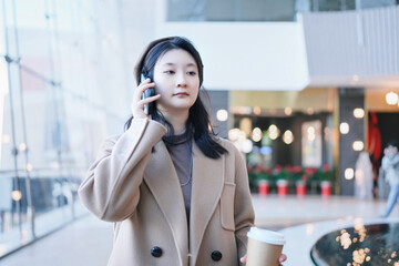 Businesswoman on the Move with Phone and Coffee