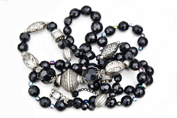 Women's jewelry with beads of black stones and silver beads.