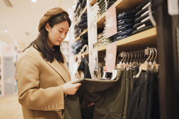 Stylish Woman Shopping for Clothes in Fashion Store