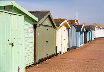 Fototapeta na wymiar Wooden beach huts on the promenade in the coastal town of Clacton-on-Sea