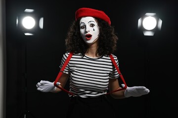 Young woman in mime costume performing on stage