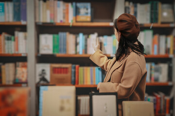 Young Woman Selecting Books in Cozy Library