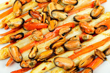 Roasted mussels with asparagus, salad,close up.