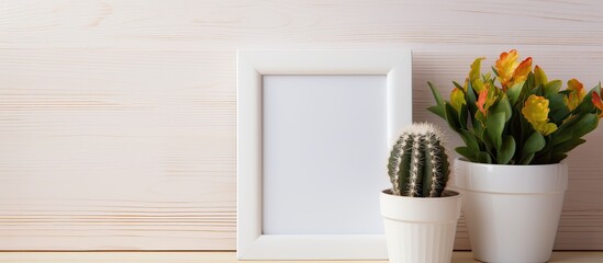 A close-up of a cactus plant in a pot positioned next to a picture frame on a table