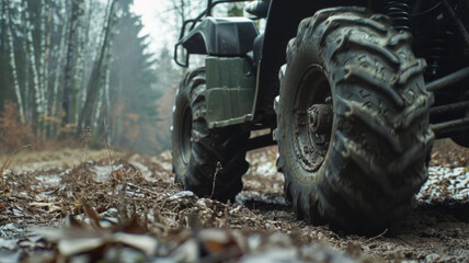 Fototapeta na wymiar Rugged tractor tire on a muddy forest trail, hinting adventure.