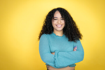 African american woman wearing casual sweater over yellow background with a happy face standing and...