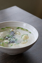 A bowl of shrimp wontons, sprinkled with seaweed and dried shrimps, traditional Chinese breakfast
