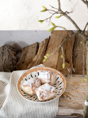 The pies are sprinkled with powdered sugar. The appetizing pies are placed in a deep ceramic bowl. View above.