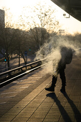 A smoking passenger on the platform at sunrise - 766293195