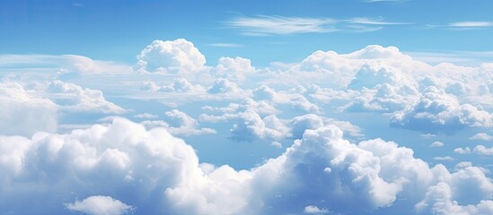 Numerous fluffy clouds of various shapes and sizes drifting peacefully across the vast expanse of the sky