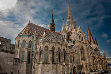 Naklejka na ściany i meble Famous historic Matthias Church in Budapest, Hungary, a must-visit landmark. Gothic architectural and decorative colorful powerful style, Catholic church with neo-Gothic style, host religious events