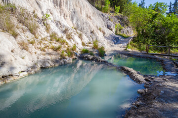 Bagni San Filippo, Natural pool with turquoise water, white rocks, and lush vegetation in Tuscany, Italy - 766301557