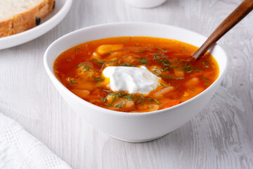 Ukrainian and russian national red borsch with sour cream closeup