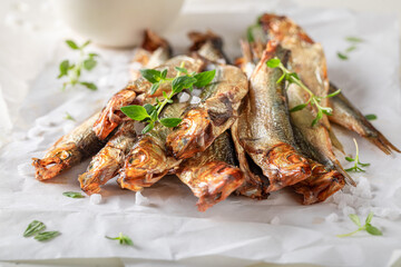 Fresh and salty smoked sprats made in a home smokehouse.
