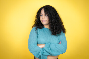 African american woman wearing casual sweater over yellow background thinking looking tired and...