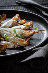 Tasty and salty smoked sprats made in a home smokehouse. - 766309989