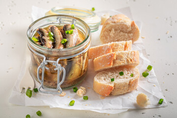 Healthy and canned smoked sprats on white food paper. - 766313740