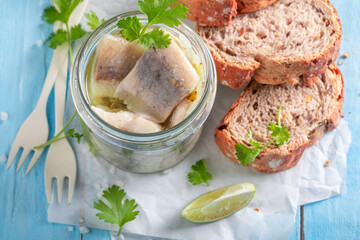 Fresh and delicious marinated herring in oil, herbs and onions. - 766314326