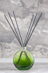 Herbal reed diffuser  close up on gray wall background