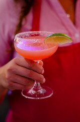 close up of a person holding a cocktail