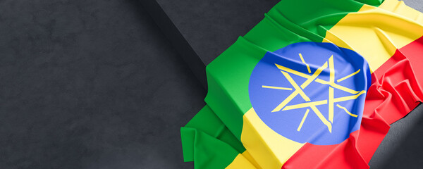 Flag of Ethiopia. Fabric textured Ethiopia flag isolated on dark background. 3D illustration