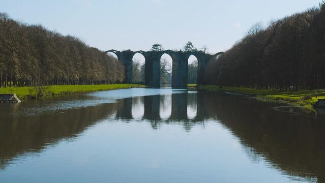 Aqueduct of Maintenon with reflection in river Eure. It is located in the Eure-et-Loir department near Paris, France