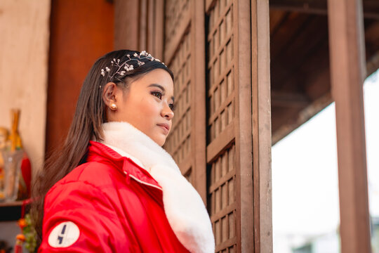 A stylish teenage girl from the Philippines visits a traditional temple during her travels in South Korea. Admiring the view outside.