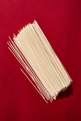 Chinese wheat noodles on red background. Retro style 80-90s food photography