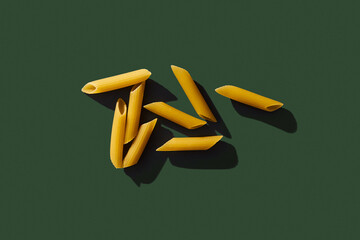 Penne pasta on blue background. Retro style food photo