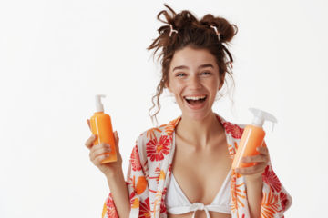 Joyful woman holding orange sunscreen bottles, tropical kimono against transparent background