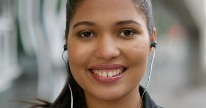 Woman, face and city with earphones for closeup, smile and listening to music for travel on holiday. Girl, person and happy in portrait with sound tech for audio streaming subscription in Mexico