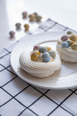 Pavlova dessert with sweet Easter Eggs. An interesting meringue dessert for the Easter table