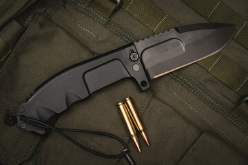 Large folding tactical knife close-up. - obrazy, fototapety, plakaty