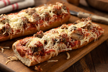 Sausage pizza bread on cutting board - 766347731