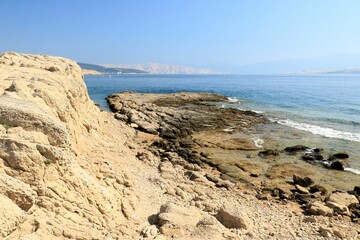 The blue sea and sandstone coast of Lopar on the island Rab, Croatia