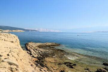 The blue sea and sandstone coast of Lopar on the island Rab, Croatia