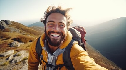 Hiker's Joy. A cheerful young hiker captures a selfie at the mountain summit, radiating joy and adventure, illustrating the intersection of outdoor sports, travel, and social media influence - obrazy, fototapety, plakaty