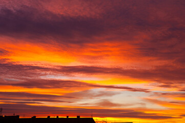 A powerful red morning glow before the appearance of the spring sun on the horizon