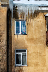 icicles on the roof of an old house - 766361161