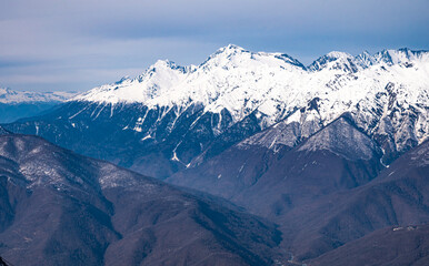 peaks of snow-capped mountains in winter - 766361325