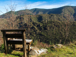 Bench in the caurel mountain range from which you can quietly appreciate the landscape. Right on the hill opposite is the Villar fort hill. Lugo, Galicia, Spain.