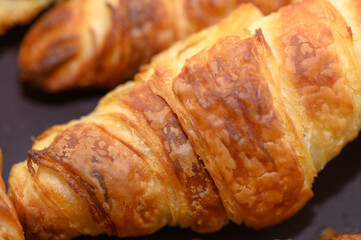 freshly baked croissants on grey wooden table, top view