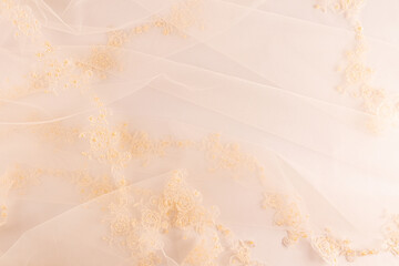 Delicate romantic bridal veil in beige color, ivory color as a background space for the design of...