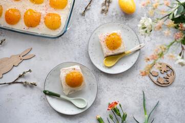 Homemade German Fried Egg Cake Spiegeleierkuchen (Spiegeleiertorte) with apricot and coconut milk pudding. Traditional Easter Dessert. Festive Easter food.